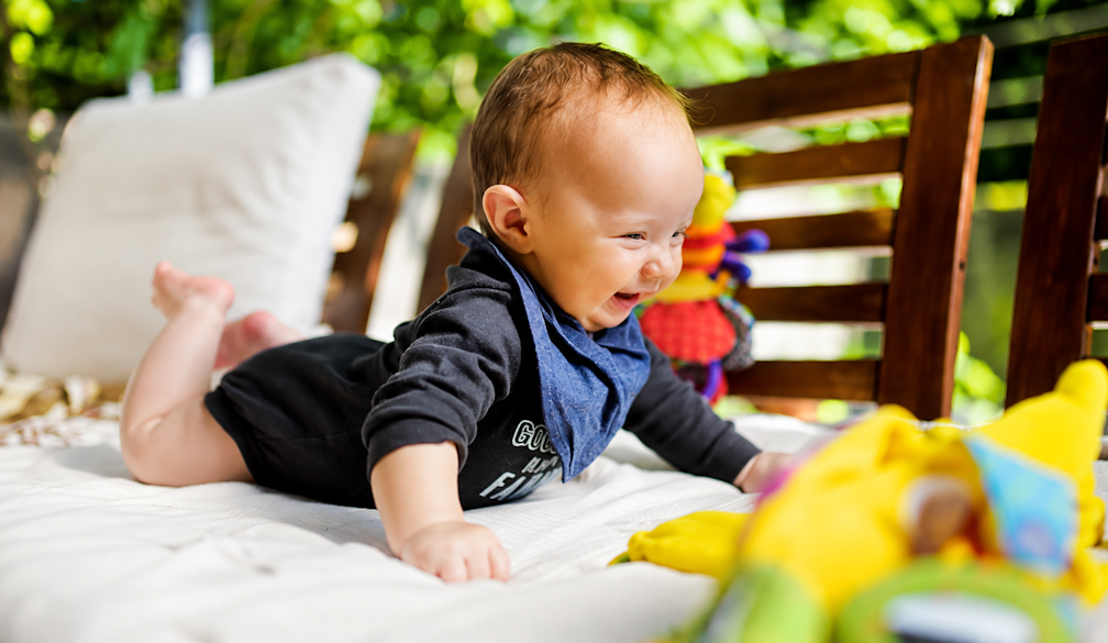 Laughing baby on a sunny porch