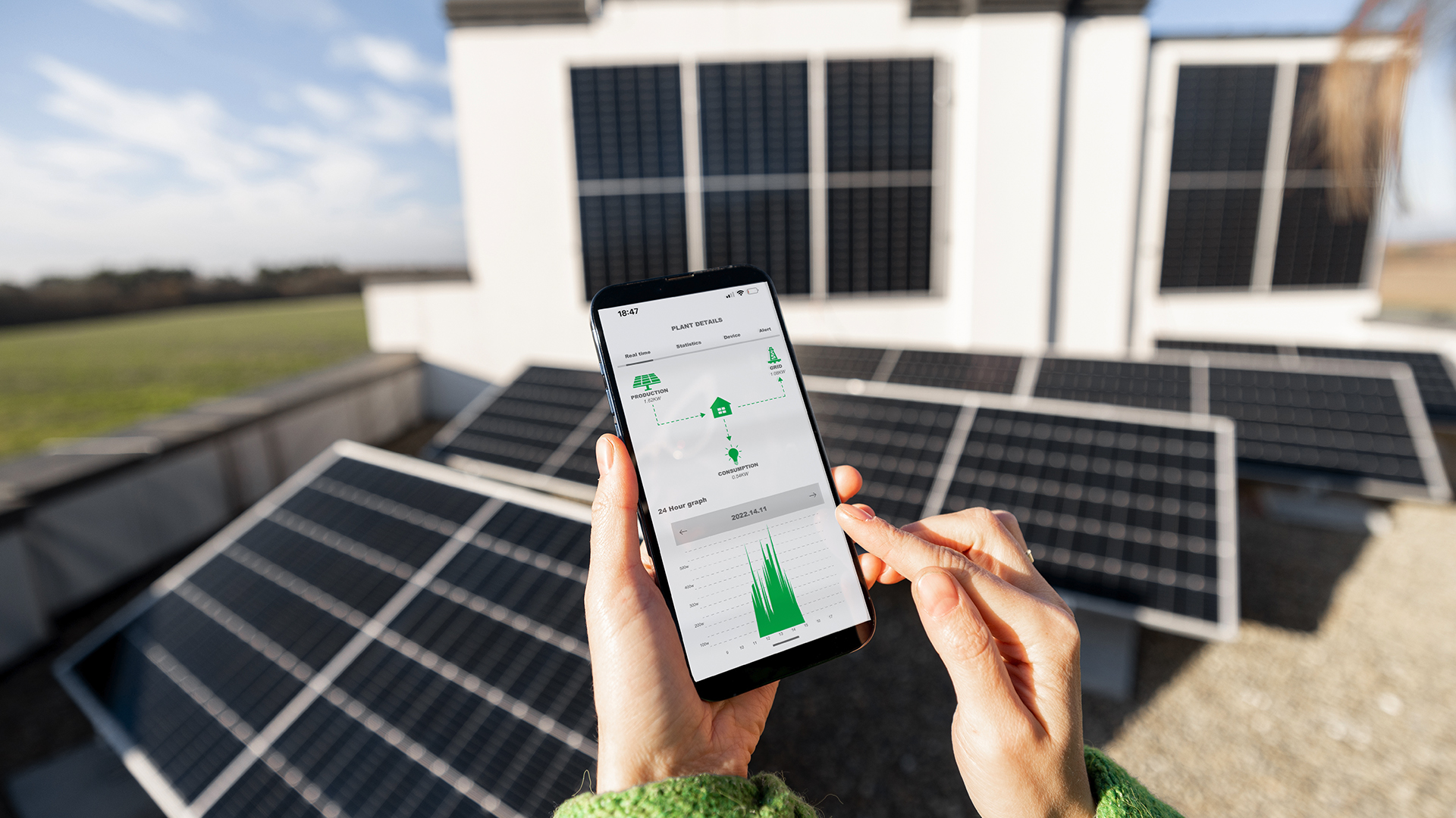 Rooftop solar energy being monitored on a mobile phone.