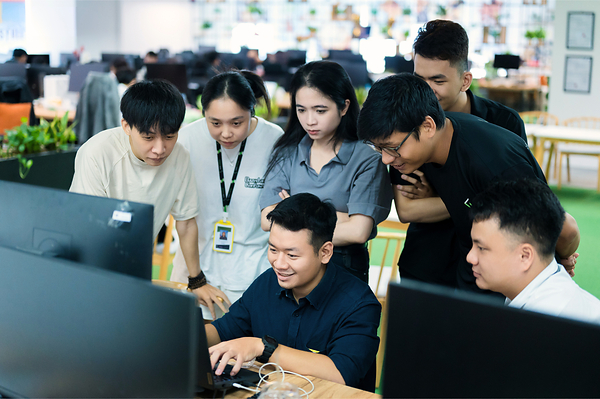 Saigon Technology engineers reviewing an AI-assisted build together Saigon Technology engineers reviewing an AI-assisted build together